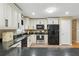 Updated kitchen featuring white cabinets, granite counters, and modern appliances at 2995 Ivy Mill Dr, Buford, GA 30519