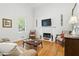 Cozy living room with a fireplace, hardwood floors, and lots of natural light at 2995 Ivy Mill Dr, Buford, GA 30519