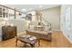 Cozy living room with hardwood floors, a comfortable sofa, and natural light from the windows at 2995 Ivy Mill Dr, Buford, GA 30519