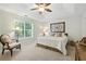 Spacious carpeted main bedroom with a large window, ceiling fan, and plenty of natural light at 2995 Ivy Mill Dr, Buford, GA 30519