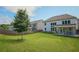 A spacious backyard with a well-kept lawn, a covered patio, and a wooden fence, perfect for outdoor entertaining at 3222 Long Creek Dr, Buford, GA 30519