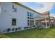 A well-manicured backyard featuring a pristine lawn, a covered patio area, and a tidy border of flowering shrubs at 3222 Long Creek Dr, Buford, GA 30519