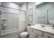 Clean bathroom with a tub/shower combo, a single sink vanity, and neutral decor at 3222 Long Creek Dr, Buford, GA 30519