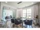 Bright dining room featuring modern decor, a glass table, and glass door to the office at 3222 Long Creek Dr, Buford, GA 30519