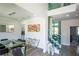 Bright dining room featuring modern decor, a glass table, and a glass staircase at 3222 Long Creek Dr, Buford, GA 30519