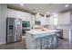 Bright modern kitchen with white cabinets, stainless steel appliances, and breakfast bar seating at 3222 Long Creek Dr, Buford, GA 30519