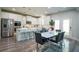 Bright kitchen featuring white cabinets, stainless steel appliances, and a breakfast bar island at 3222 Long Creek Dr, Buford, GA 30519