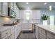 Updated kitchen with white cabinets, stainless steel appliances, and modern countertops at 3222 Long Creek Dr, Buford, GA 30519