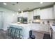 Bright kitchen with white cabinets, stainless steel appliances, and island seating at 3222 Long Creek Dr, Buford, GA 30519