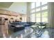 Open-concept living room featuring a high ceiling, large windows, and modern furniture at 3222 Long Creek Dr, Buford, GA 30519