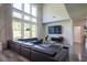 Living room featuring a high ceiling, large windows with curtains, and modern furniture at 3222 Long Creek Dr, Buford, GA 30519