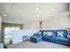 Cozy loft featuring a comfortable blue sectional couch, modern decor, and carpet floors at 3222 Long Creek Dr, Buford, GA 30519