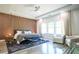 Modern bedroom with wood accent wall, recessed lighting, and a cozy sitting area with stylish decor at 3222 Long Creek Dr, Buford, GA 30519