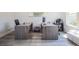 Bright home office with two desks, modern furniture, and a large window at 3222 Long Creek Dr, Buford, GA 30519