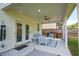 Covered patio with comfortable seating, ideal for outdoor entertaining at 3222 Long Creek Dr, Buford, GA 30519