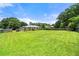 This backyard features a grassy lawn, a wooden fence, and lush trees at 3405 Leisure Ln, Atlanta, GA 30349