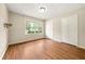 This bedroom features neutral walls, hardwood floors, and a large window at 3405 Leisure Ln, Atlanta, GA 30349