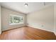 Well-lit bedroom with wood flooring and a bright window view at 3405 Leisure Ln, Atlanta, GA 30349
