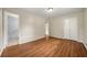 This bedroom features neutral walls, hardwood floors, and ensuite bathroom at 3405 Leisure Ln, Atlanta, GA 30349