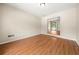Bright bedroom featuring wood flooring and access to other rooms of the home at 3405 Leisure Ln, Atlanta, GA 30349