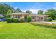 Charming brick home with manicured lawn and lush greenery creating an inviting curb appeal at 3405 Leisure Ln, Atlanta, GA 30349