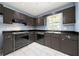 Functional kitchen with black appliances, matching cabinetry and bright geometric tiled flooring at 3405 Leisure Ln, Atlanta, GA 30349