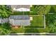 Aerial view of home with large backyard, trees, fence, and green lawn at 3451 Carriage Chase Rd, Atlanta, GA 30349