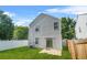 Backyard view of home, featuring a vinyl fence, lush lawn, and sliding glass door at 3451 Carriage Chase Rd, Atlanta, GA 30349