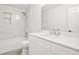 Bright bathroom featuring tiled walls, modern fixtures, shower and tub combination at 3451 Carriage Chase Rd, Atlanta, GA 30349