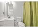 Clean bathroom with a toilet, sink and shower curtain at 3451 Carriage Chase Rd, Atlanta, GA 30349