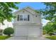 Two-story home with a two-car garage and mature landscaping at 3451 Carriage Chase Rd, Atlanta, GA 30349
