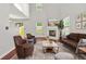 Open-concept living room with a modern fireplace and hardwood floors at 3451 Carriage Chase Rd, Atlanta, GA 30349