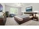 Cozy main bedroom with neutral tones, a large window, and a ceiling fan at 3451 Carriage Chase Rd, Atlanta, GA 30349