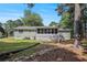View of home's backyard, features a patio and lots of shade from the surrounding trees at 2780 Highpoint Rd, Snellville, GA 30078