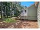 View of home's backyard, features a patio and lots of shade from the surrounding trees at 2780 Highpoint Rd, Snellville, GA 30078