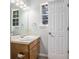 Bathroom featuring a vanity, sink, and decorative light fixture, along with a window for natural light at 2780 Highpoint Rd, Snellville, GA 30078