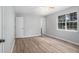 Bright bedroom with light gray walls, ceiling fan, and natural light from a window overlooking the yard at 2780 Highpoint Rd, Snellville, GA 30078