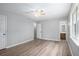 Neutral bedroom with light gray walls, wood look floors, ceiling fan, closet, and attached bathroom at 2780 Highpoint Rd, Snellville, GA 30078