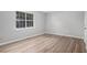Bedroom with light gray walls, a window with natural light, and wood look flooring at 2780 Highpoint Rd, Snellville, GA 30078