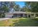 Charming single-story home features a screened-in front porch, attached garage, and a spacious front lawn at 2780 Highpoint Rd, Snellville, GA 30078