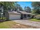View of the home showing the attached garage, screen porch, and light green painted siding at 2780 Highpoint Rd, Snellville, GA 30078