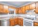 Close up on the kitchen featuring wood cabinets, stainless steel appliances and a gas range at 2780 Highpoint Rd, Snellville, GA 30078