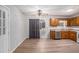 Open kitchen and dining area featuring wood cabinets and laminate flooring at 2780 Highpoint Rd, Snellville, GA 30078