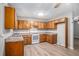 Traditional kitchen features wood cabinets, laminate countertops, white appliances, and light wood-look flooring at 2780 Highpoint Rd, Snellville, GA 30078