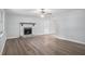 Living room with a ceiling fan and fireplace featuring neutral colored walls and wood laminate flooring at 2780 Highpoint Rd, Snellville, GA 30078