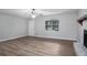 Bright living room with wood laminate flooring, ceiling fan and a stone fireplace at 2780 Highpoint Rd, Snellville, GA 30078