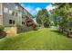 Expansive backyard with lush lawn, mature trees, and well-maintained landscaping at 4715 Mcintosh Drive Dr, Cumming, GA 30040