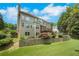 Large backyard featuring a plush lawn, multilevel patio, and manicured landscaping at 4715 Mcintosh Drive Dr, Cumming, GA 30040