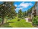 Manicured backyard with lush lawn and mature trees offers a tranquil outdoor space at 4715 Mcintosh Drive Dr, Cumming, GA 30040