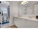 Bathroom with double sink vanity, large mirror, and a shower-tub combo at 4715 Mcintosh Drive Dr, Cumming, GA 30040